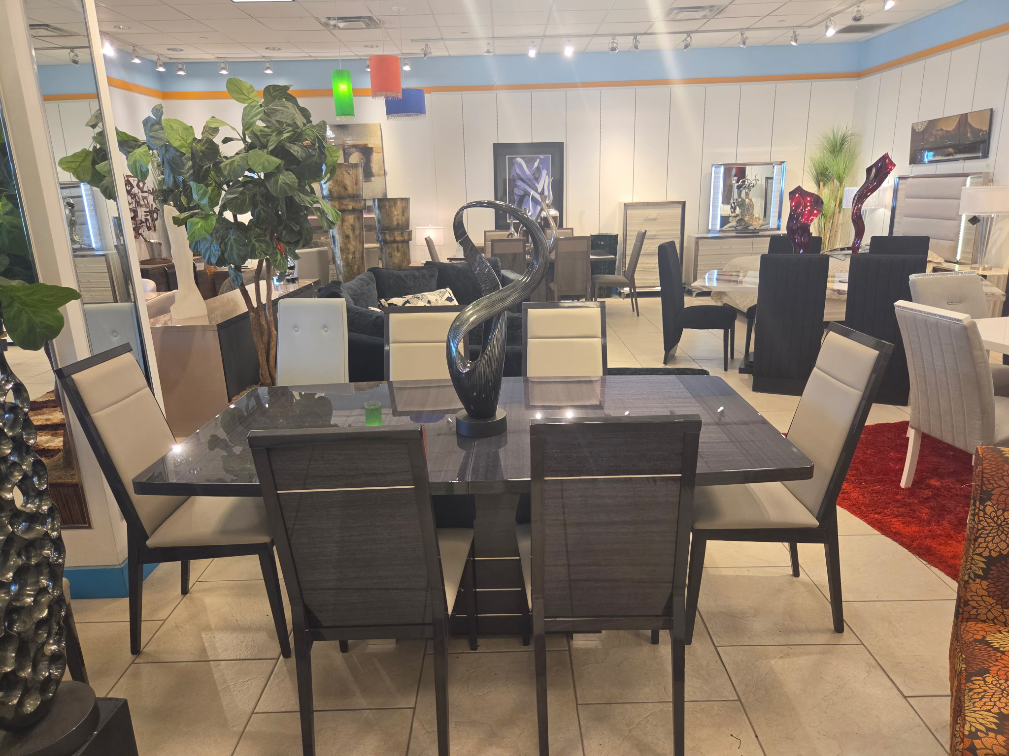 Dark wood dining table with upholstered chairs and showroom decor
