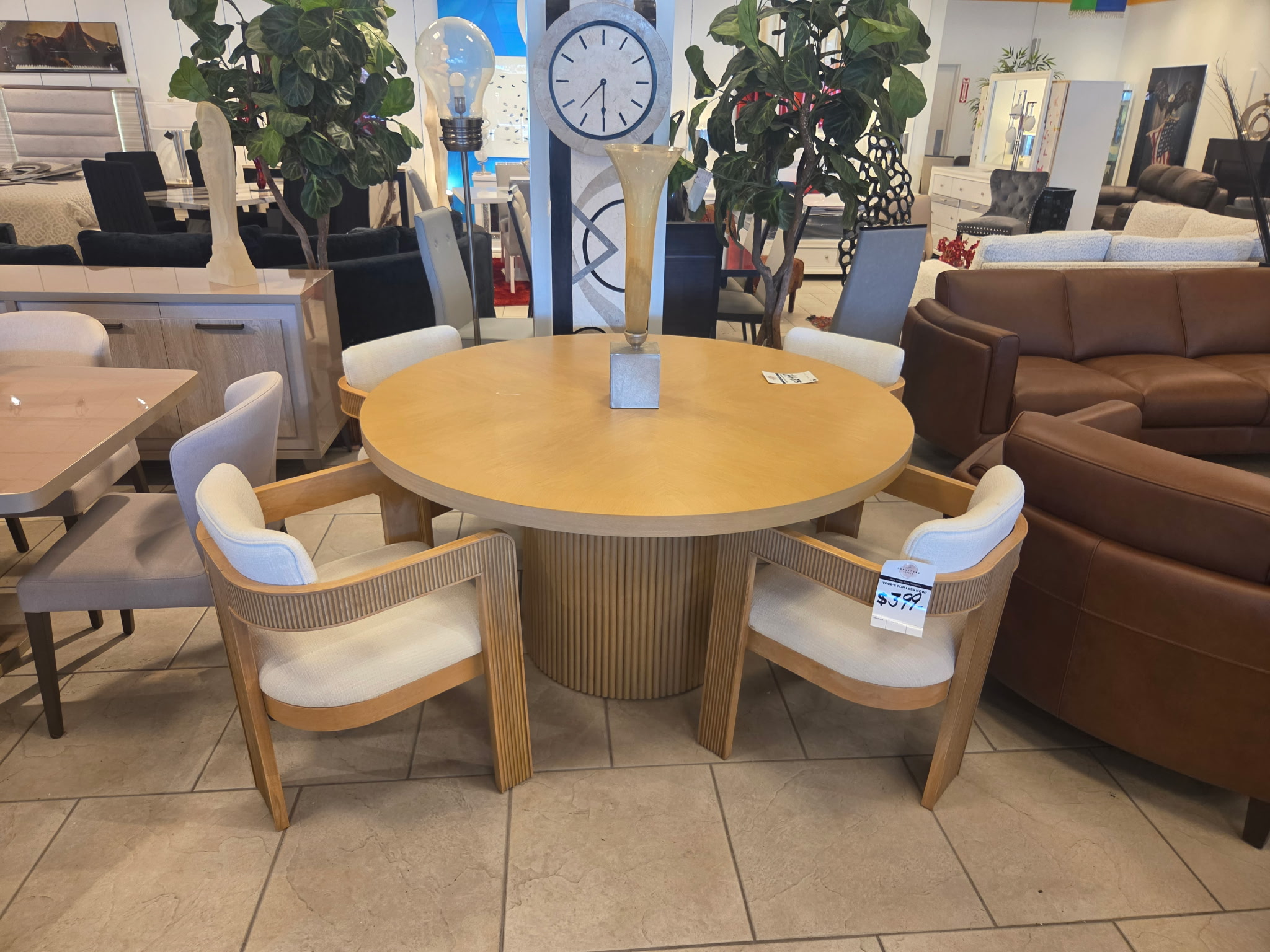 Round wood dining table with curved upholstered chairs