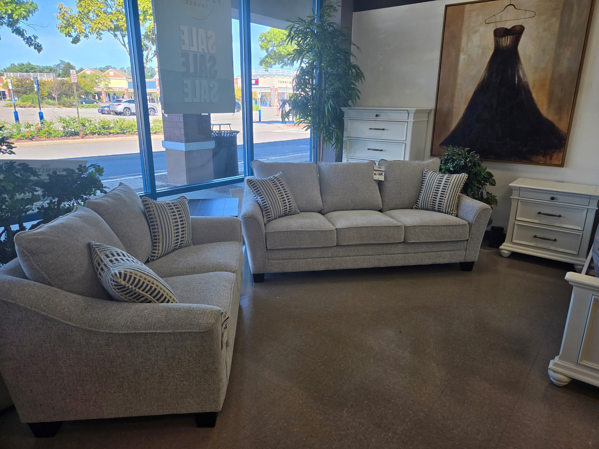 Sofa and accent chair living room display near the showroom windows