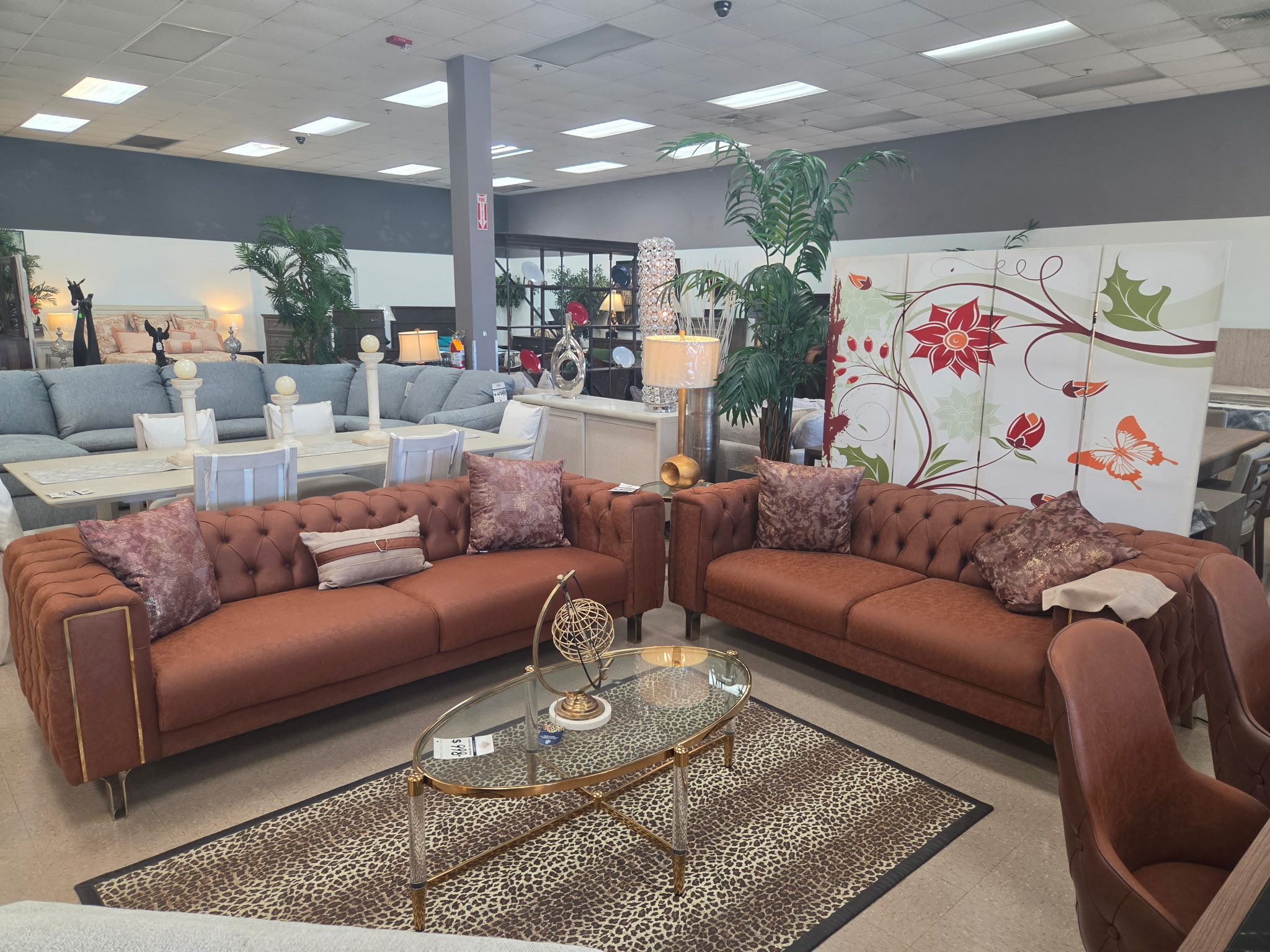 Tufted leather sofa set with accent tables and decor