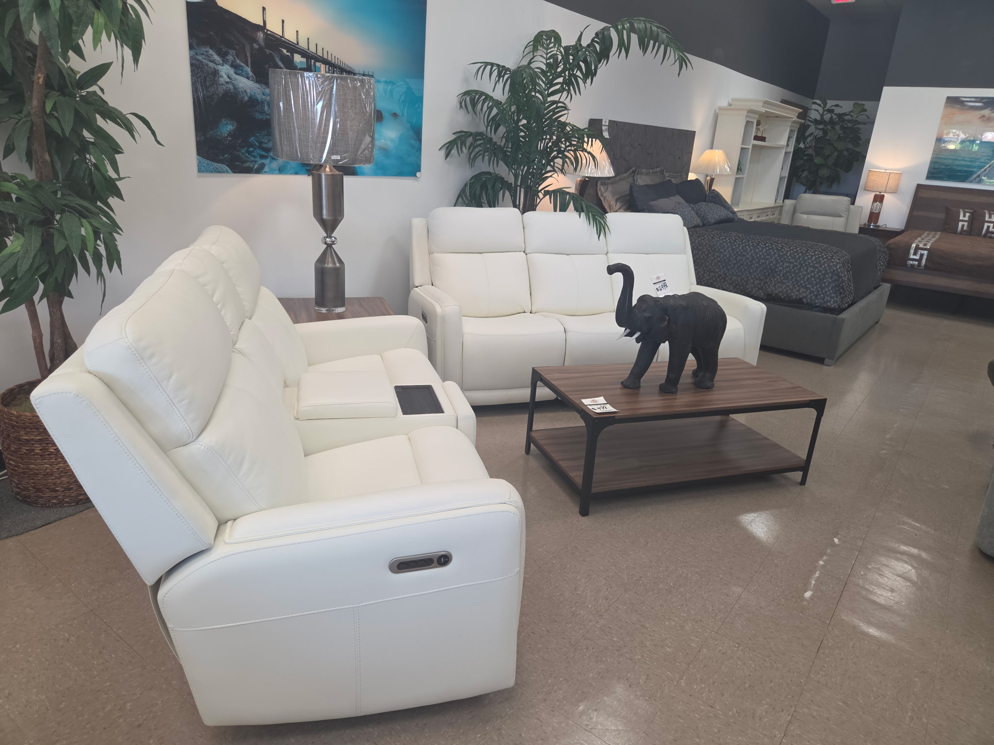 White reclining sofa and living room seating in the showroom