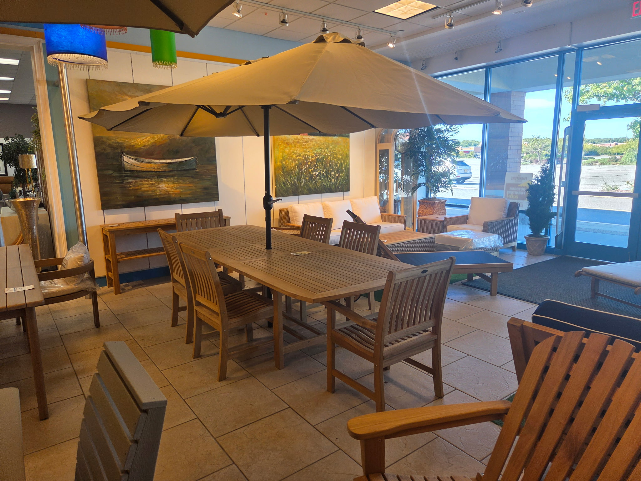 Outdoor dining table with umbrella in the Riverhead showroom