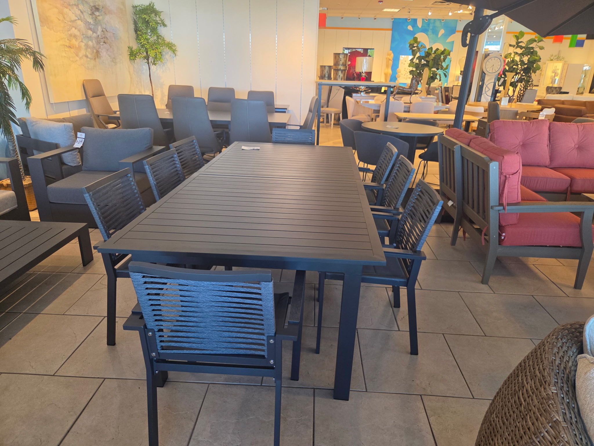 Long outdoor dining table with chairs and colorful patio seating