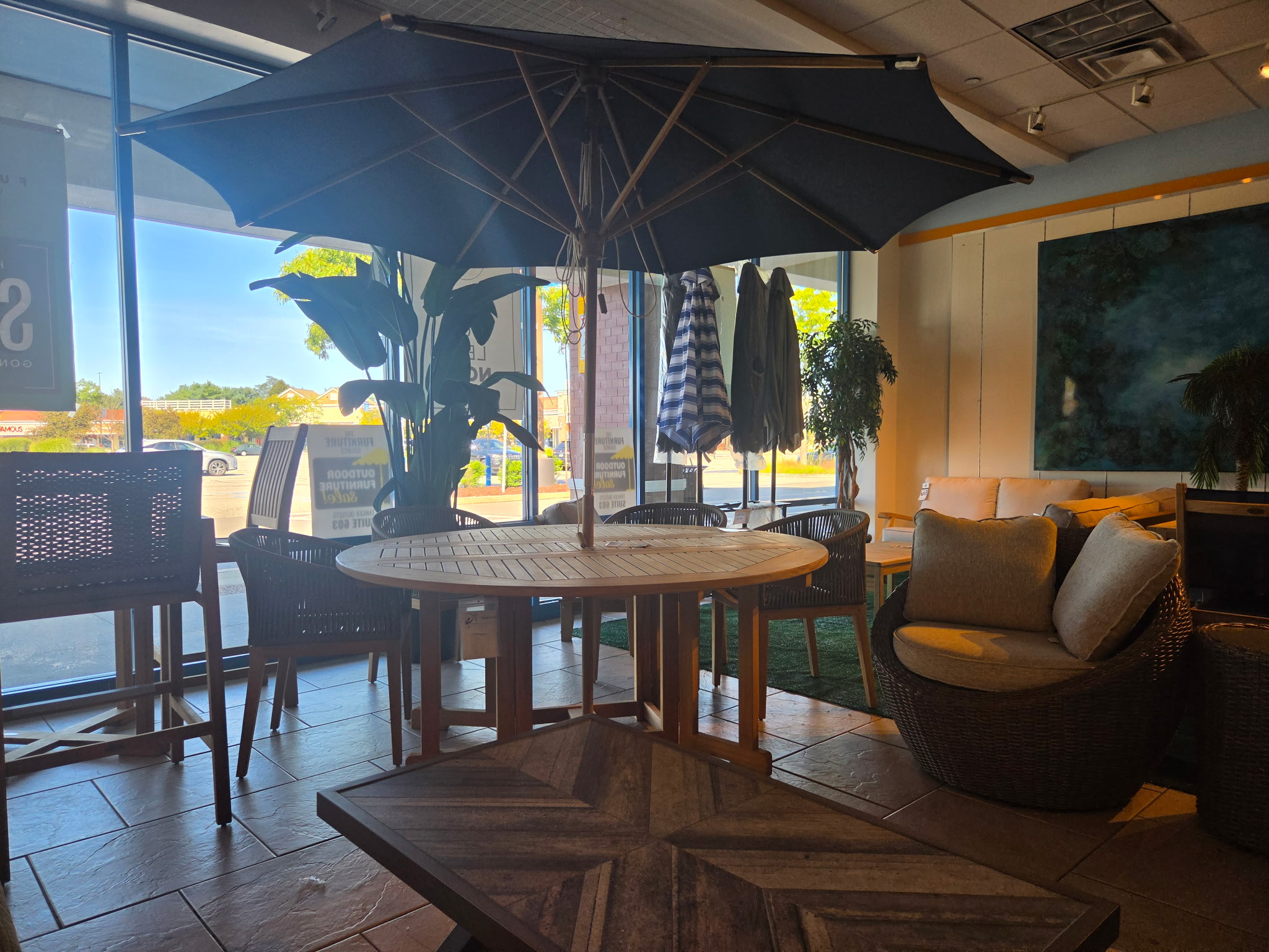 Round outdoor dining table with umbrella and patio seating