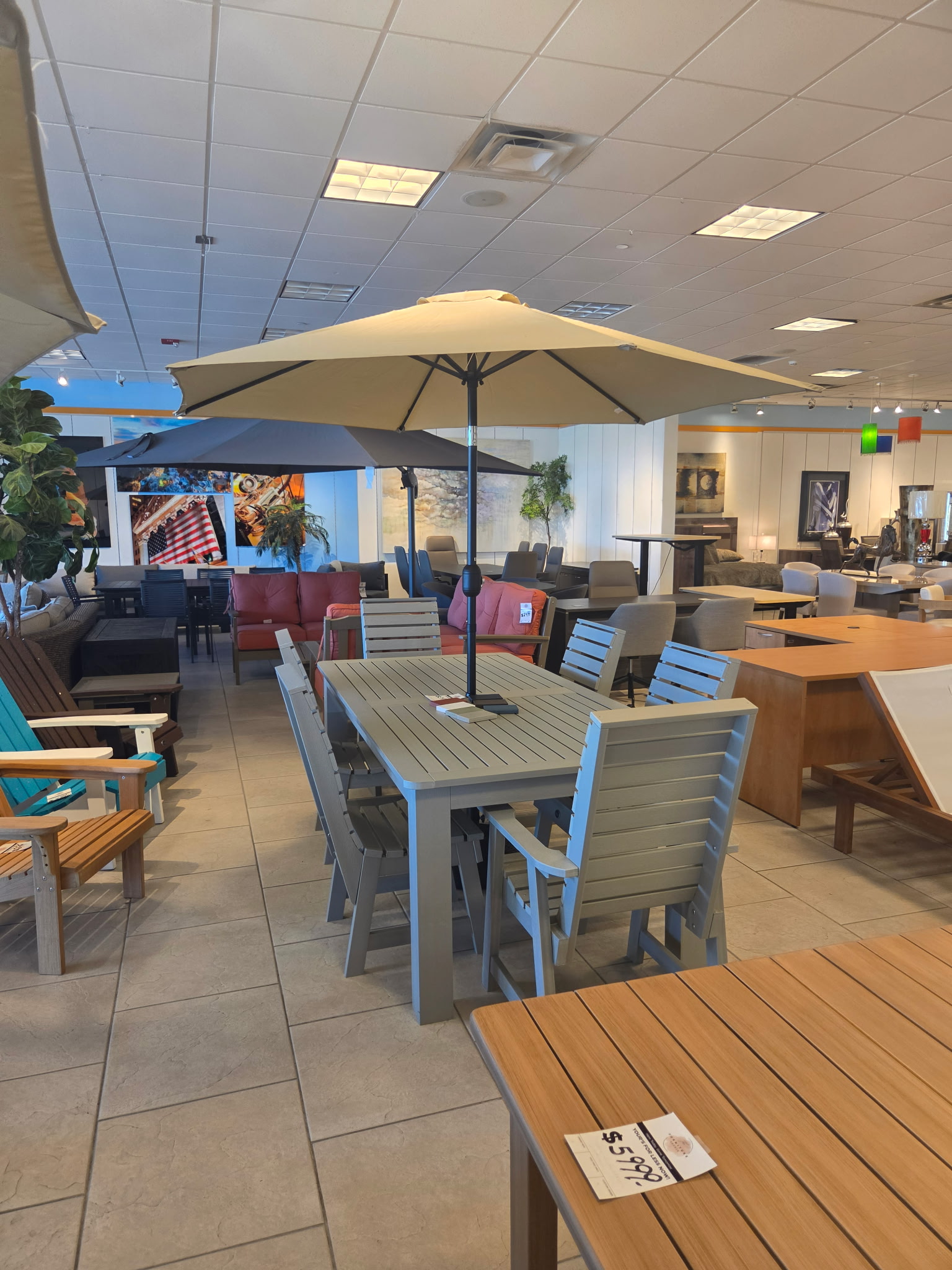Outdoor dining sets and patio furniture inside The Furniture Source showroom